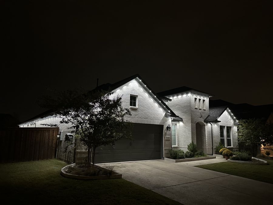 Warm white soffit lighting on brick