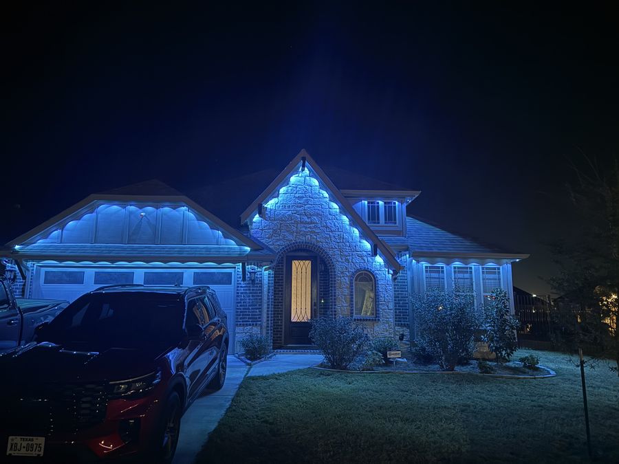 Home with blue permanent soffit lighting at night